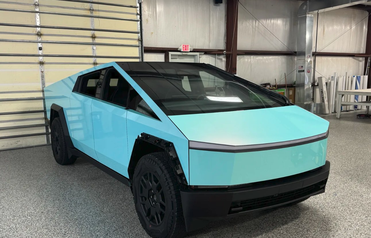 2024 Tesla Cybertruck wrapped in EVOLV Gloss Metal Hawaii Mint, front three-quarter view in the shop